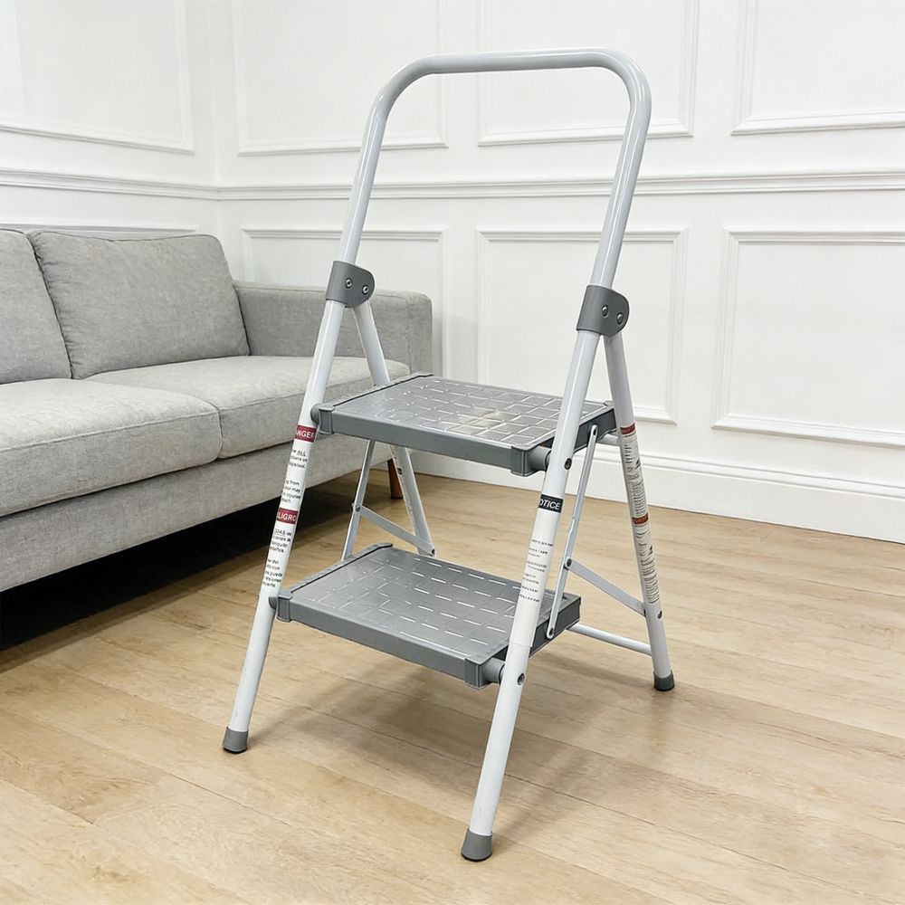 2-step folding step stool with a handle, placed in a modern living room