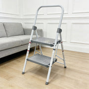 2-step folding step stool with a handle, placed in a modern living room