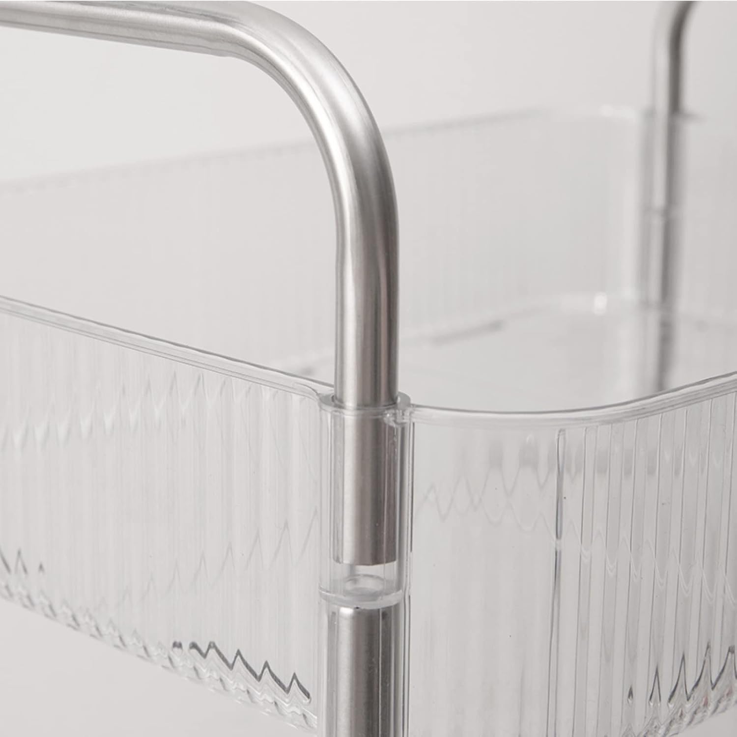 Clear acrylic basket of 4-Tier Rolling Storage Cart with metal handle on a light gray background