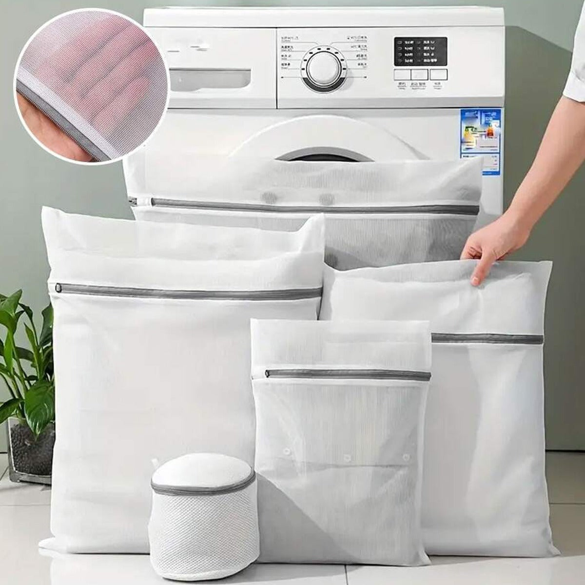 4 Pcs  Mesh Laundry Washing Bags Set in front of a washing machine.