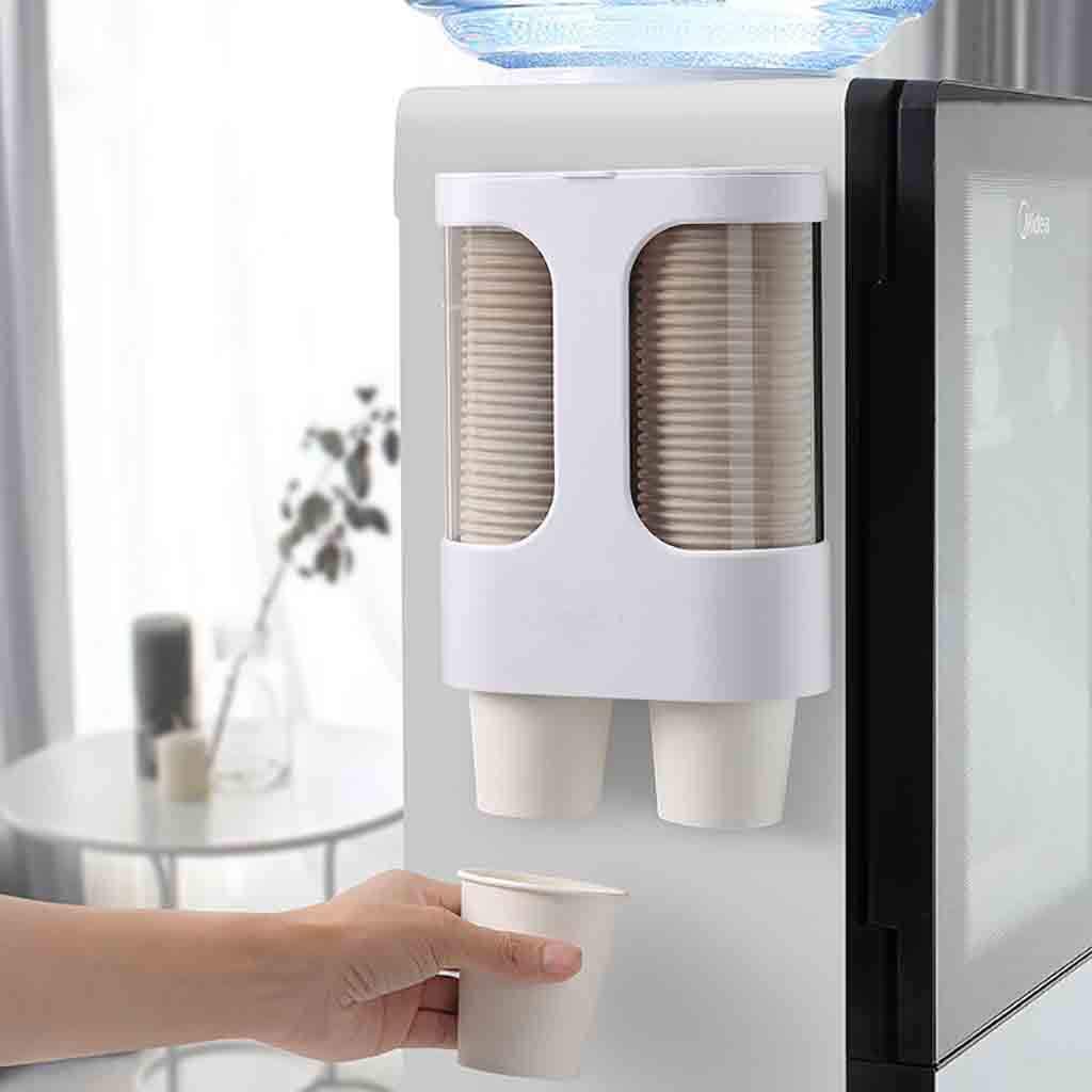 A person stands in front of Wall Mount Paper Cup Dispenser - holding a cup