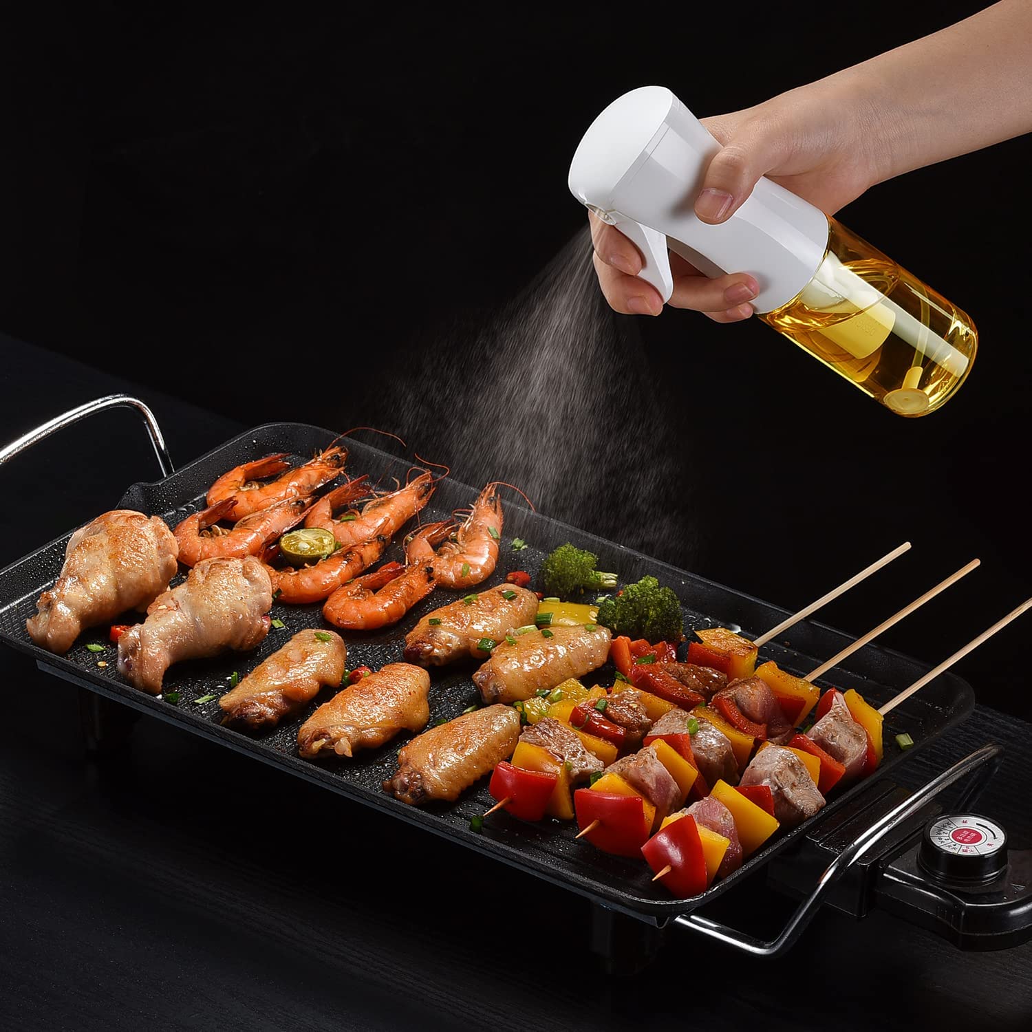 Someone is using a 200ml Kitchen Cooking Salad BBQ Oil Sprayer on food
