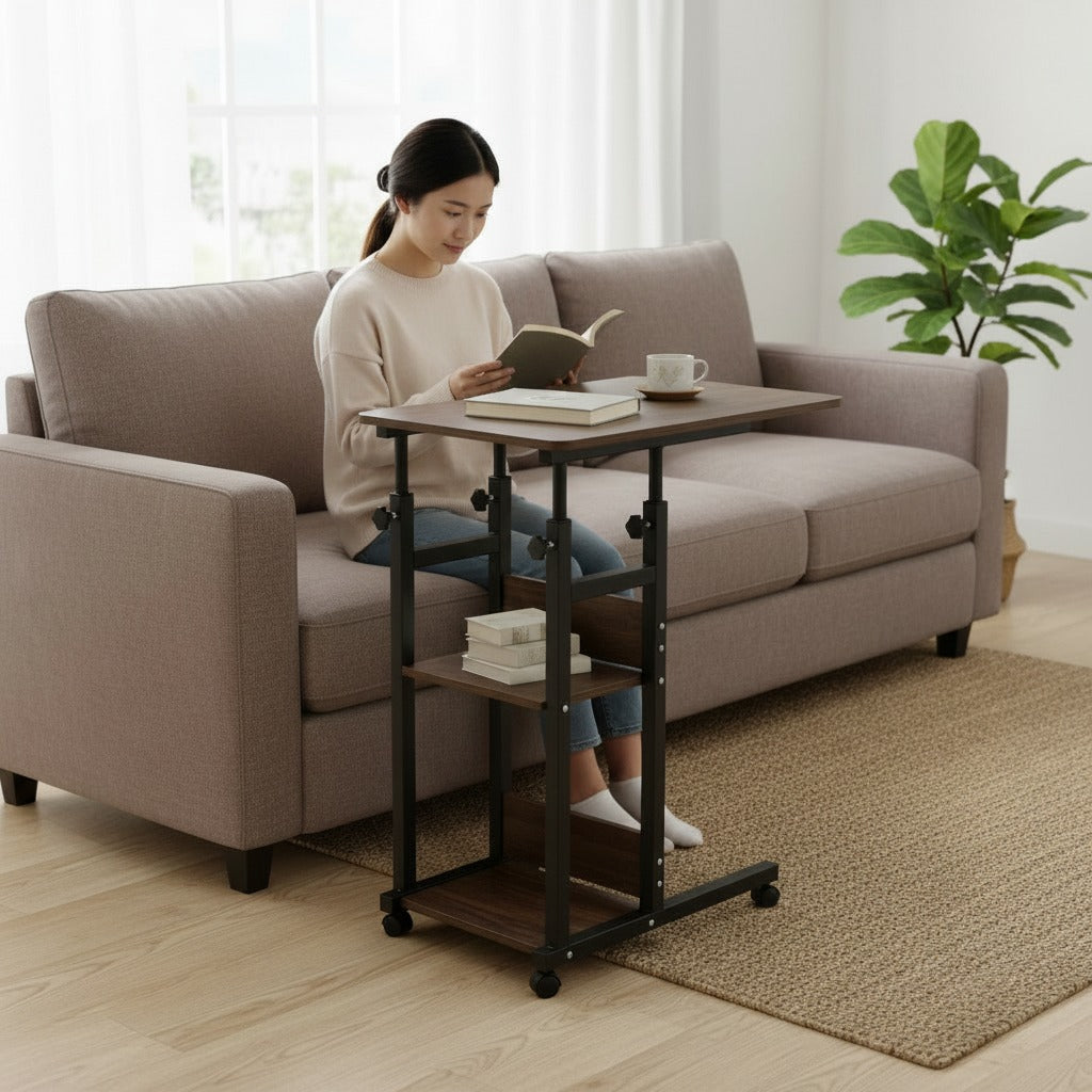 Woman reading a book on a Adjustable Overbed Laptop Table in a living room.