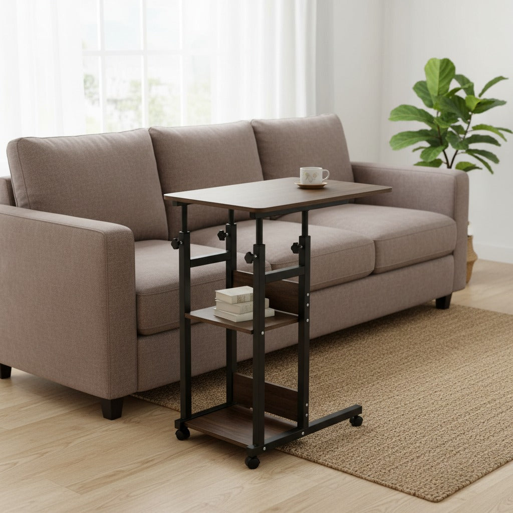Adjustable Overbed Laptop Table next to a beige sofa in a living room setting with a plant in the corner.