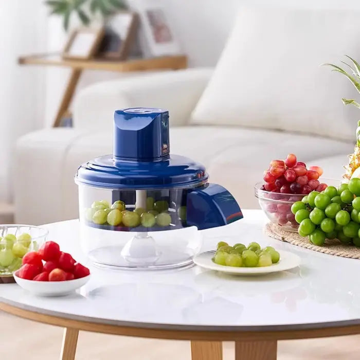 Automatic Electric Fruit & Vegetable Peeler with fruits on a white table