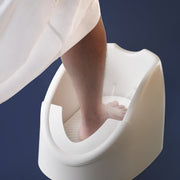 A Person is Washing His Legs Using Automatic Wudu Foot Washer Basin.