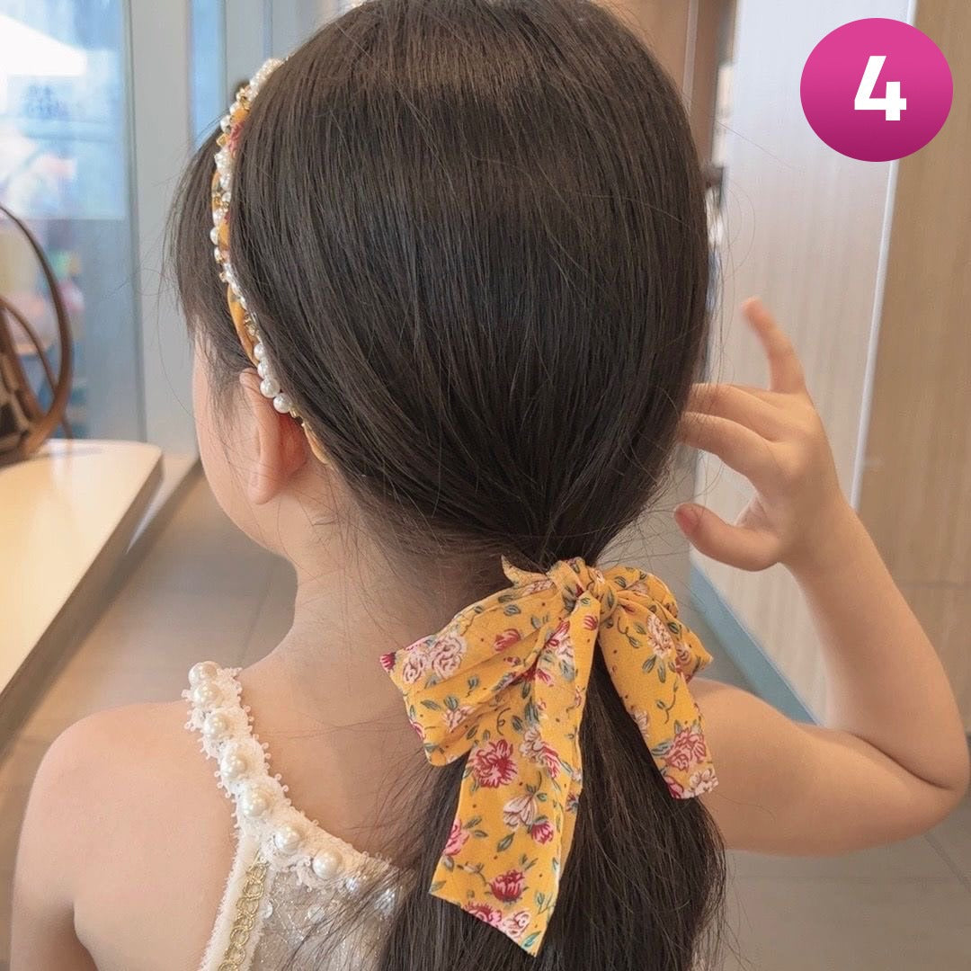 A Girl Wearing Yellow Printed Retro Chain Hair Loop Headband.
