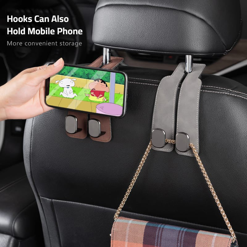 A Person is Placing Phone on the Car Headrest Hanging Hook.