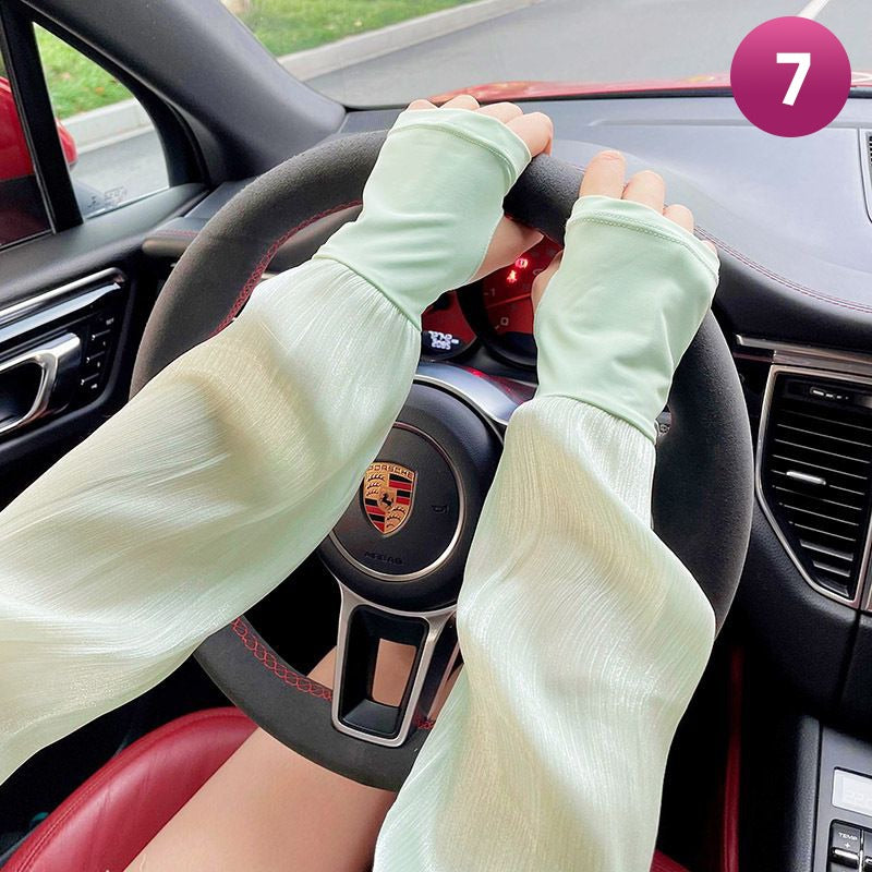 A Women is Wearing Women Summer Arm Sleeves While Driving.
