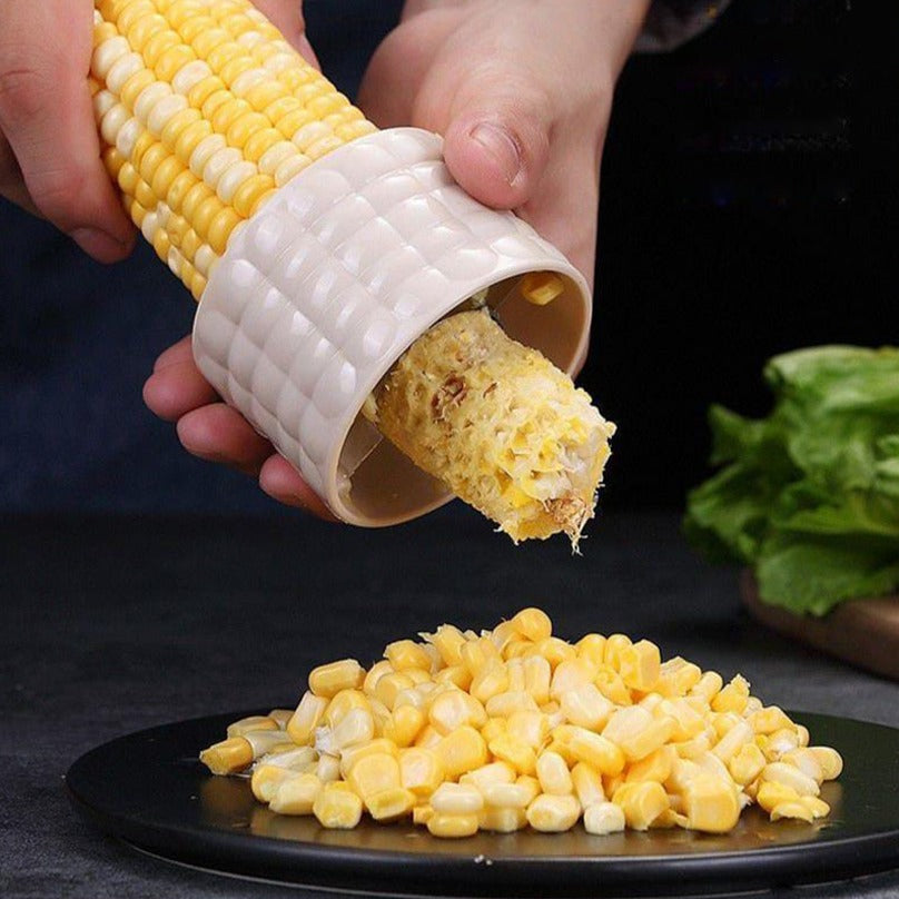 A Person Peeling Corn Using  Corn Stripper Peeler.