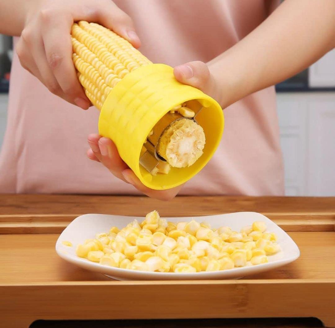 A Person is Peeling Corn Using Corn Stripper Peeler.
