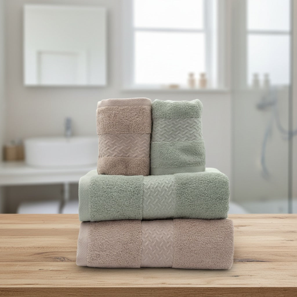 Stack of Cotton Bath & Face Towel Set on a wooden surface with a bathroom in the background