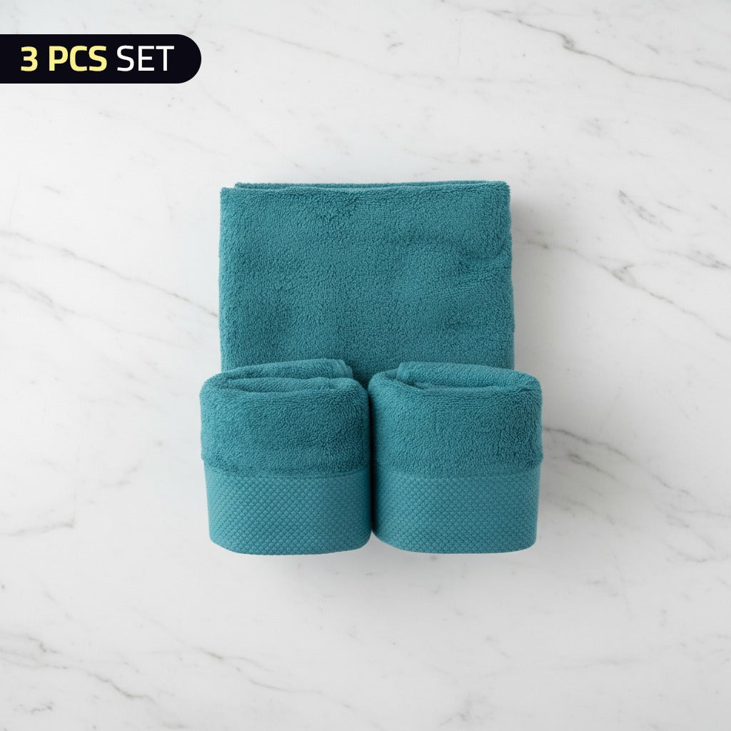 Set of Cotton Bath & Face Towel Set on a white marble surface