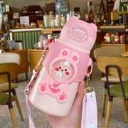 A Person is Holding Cute Cartoon Bear Water Bottle for Kids.
