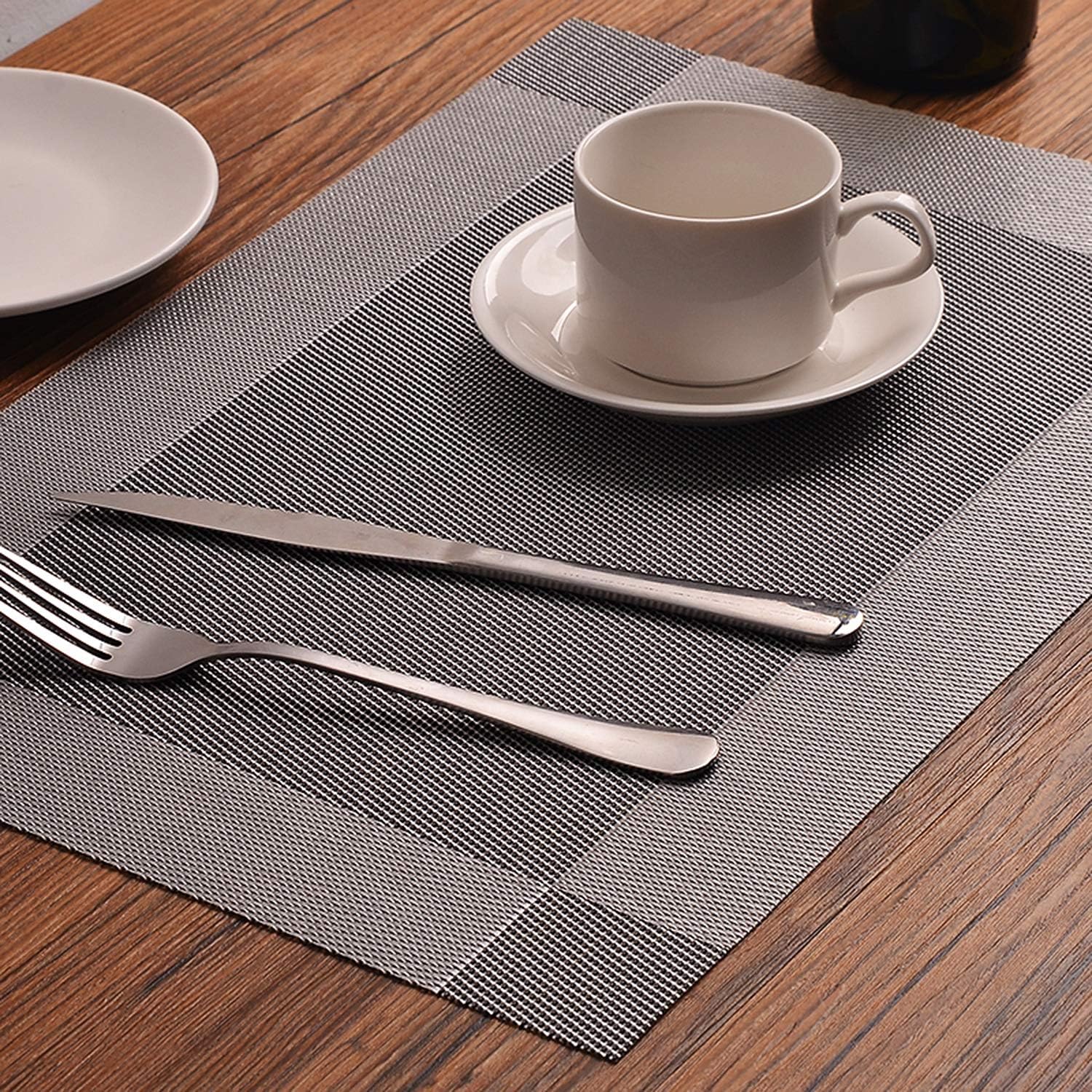 Cup and saucer with cutlery on a Dining Table Placemats