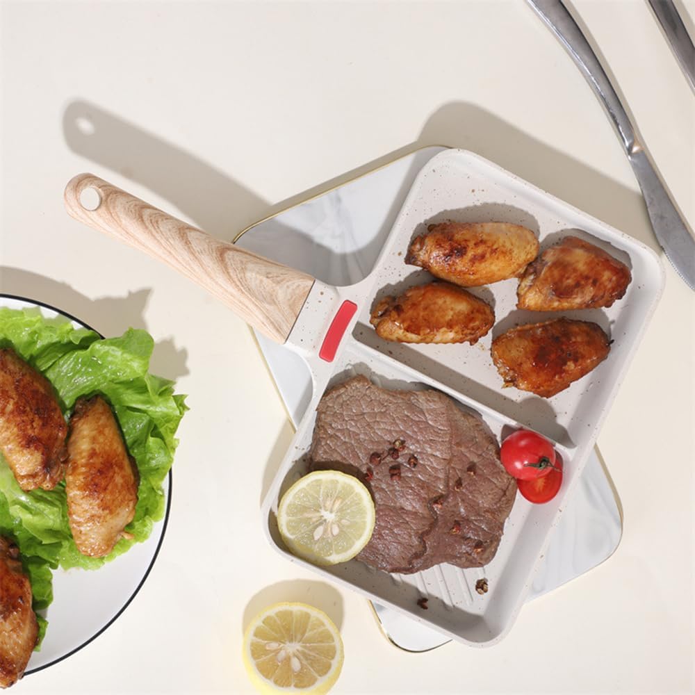 Plated meal with steak, chicken is arranged on Double-Hole Frying Pan and vegetables on a white surface