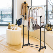 A Double Pole Portable Garment Rack Organized with Clothes.