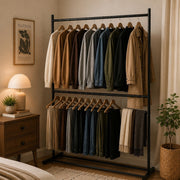 Double Rod Garment Drying Rack with various jackets and pants in a bedroom setting.