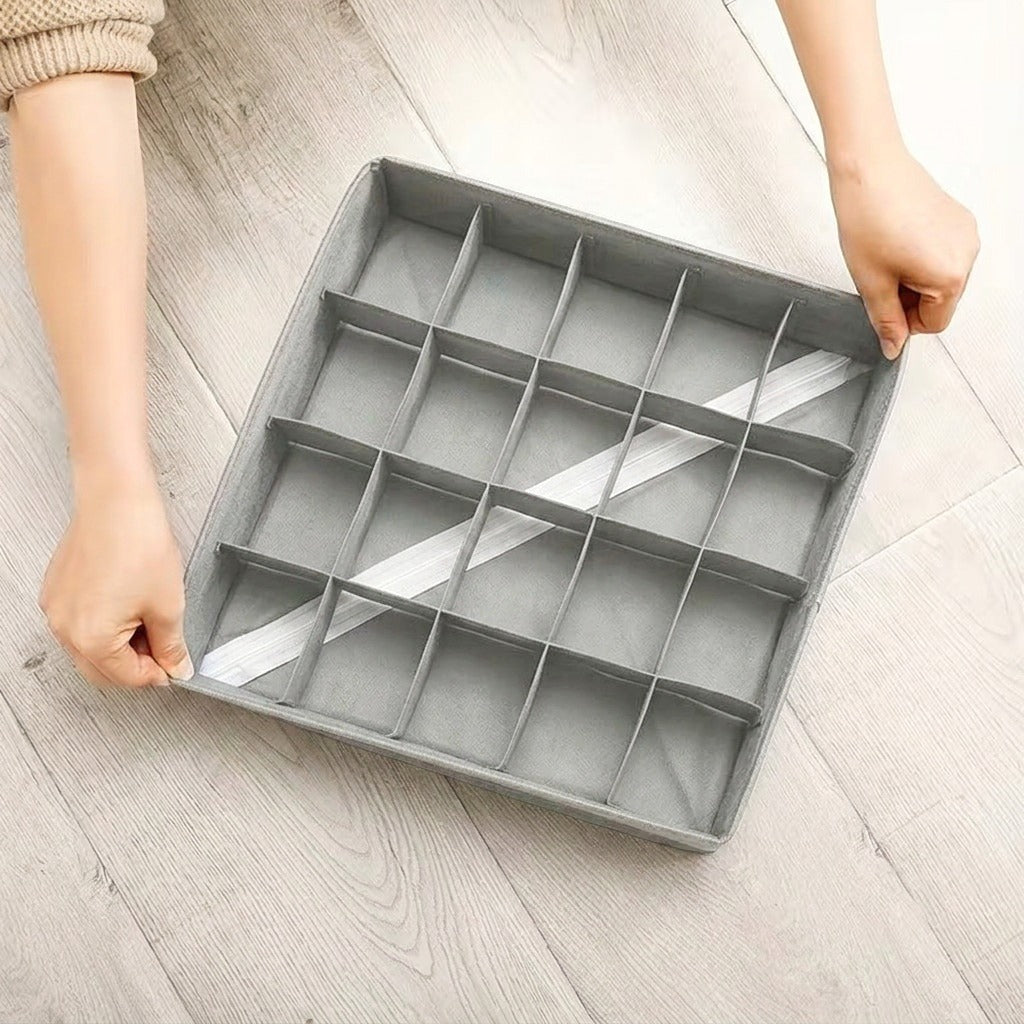Drawer Organizer Storage Box held by two hands on a light wooden floor.