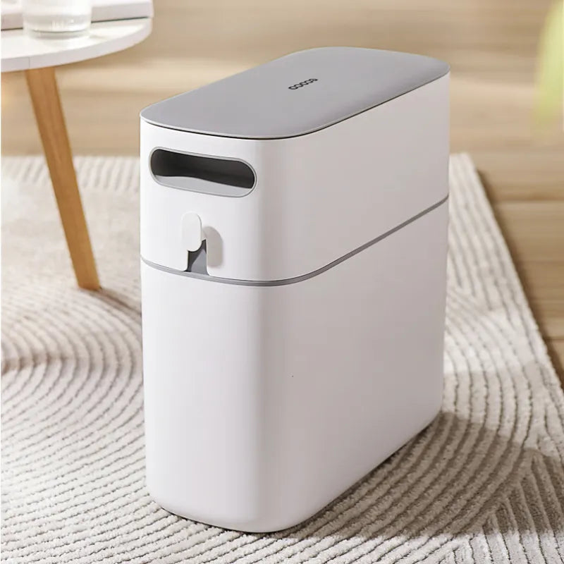 Press-type Trash Can placed on top a carpet in a hall near to table