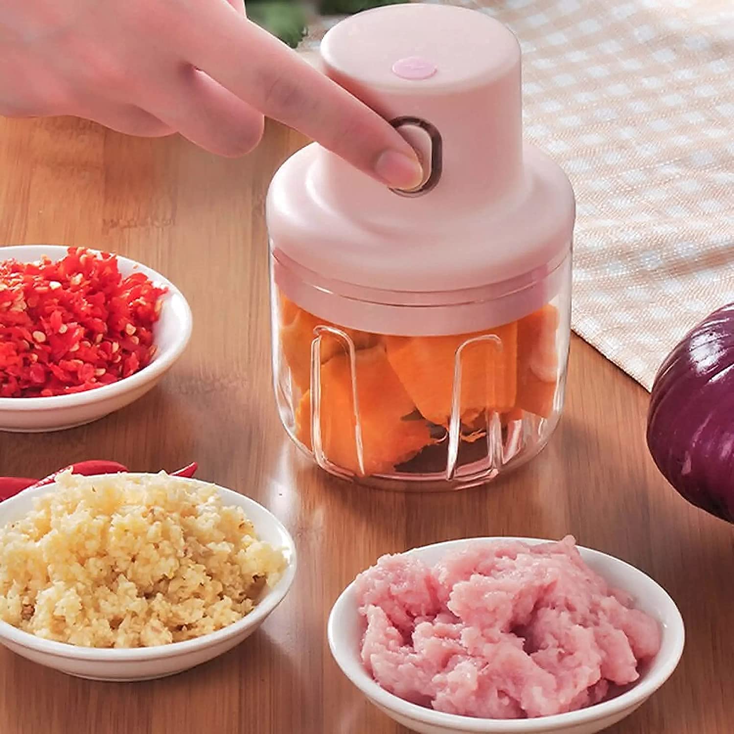 A Person is Operating Electric Garlic Chopper.
