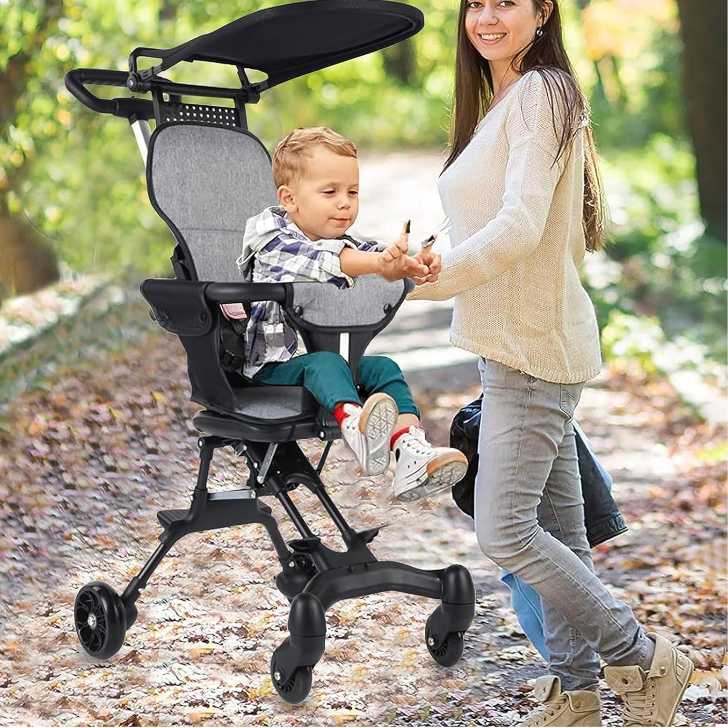 Woman walking with a child in a stroller on a leafy path