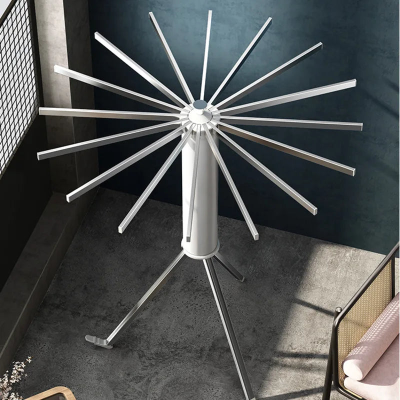 The Foldable Clothes Hanger Airer Umbrella, Installation-Free Laundry Rail with 16 Drying Rods is placed on the floor next to the window