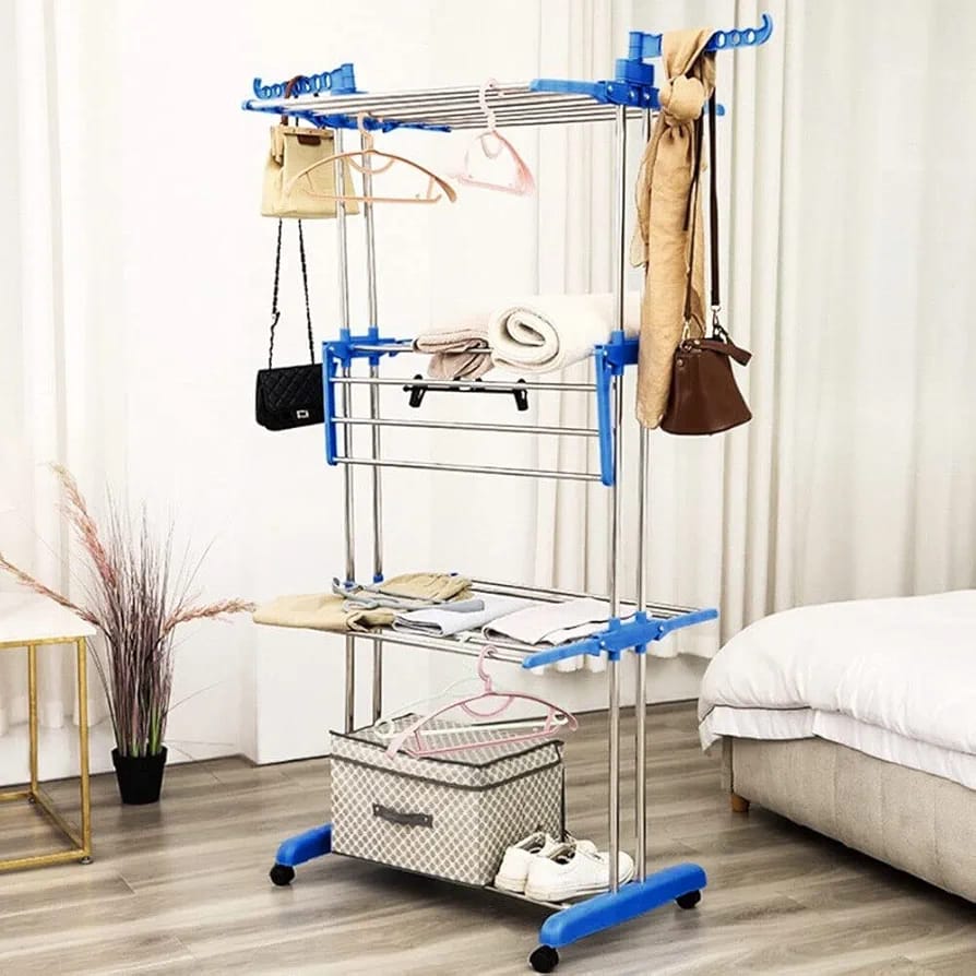 Folding 3 Layer Cloth Drying Rack Stand organized with clothes and bags.