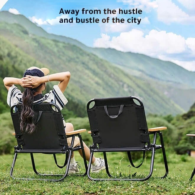 A Woman is Resting on a Folding Camping Chair