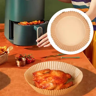 A lady cooking with the help of disposable air fryer paper liners 