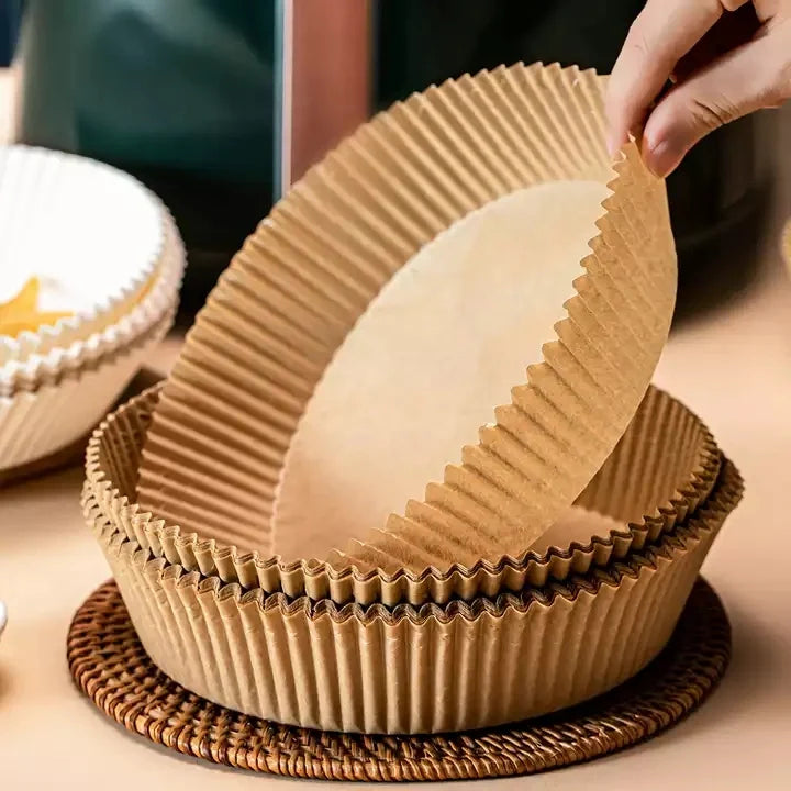 A person taking disposable air fryer paper liners