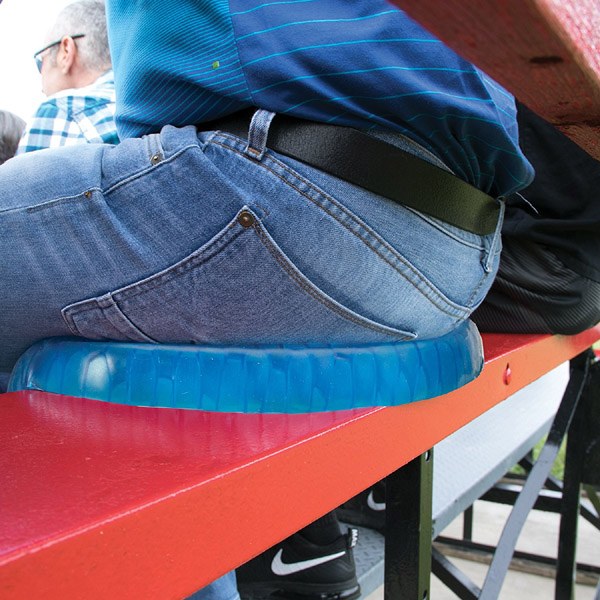 Someone sitting with the assistance of an Egg Sitter Gel Chair Cushion