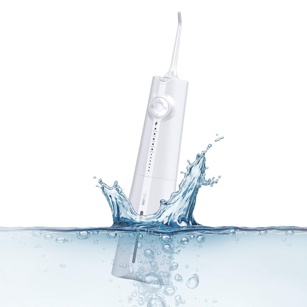 Green Lion Portable Oral Irrigator is Dipped in Water.