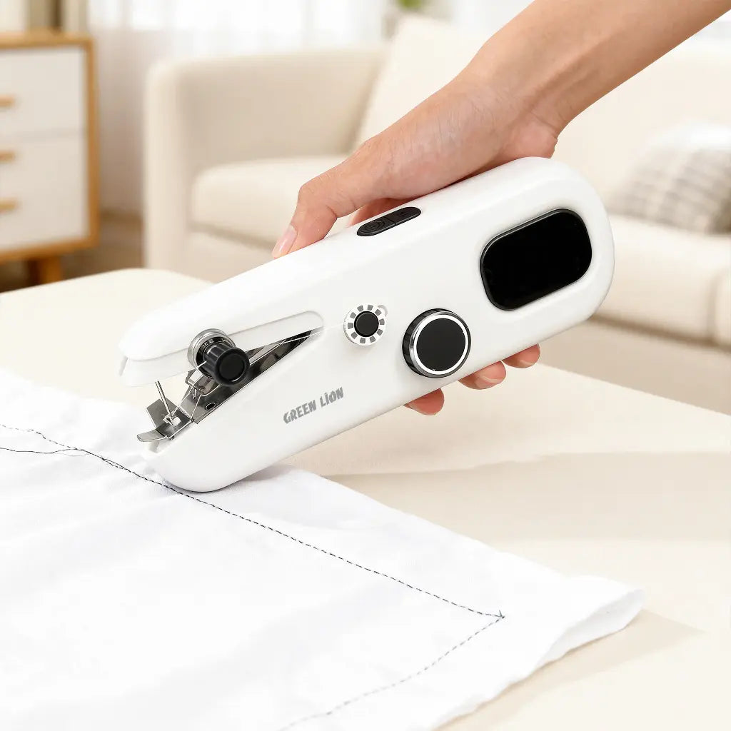 Handheld sewing machine being used on a white fabric with a neutral background