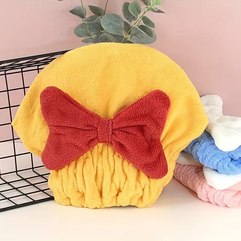 Yellow Hair Drying Cap with a red bow on a pink background