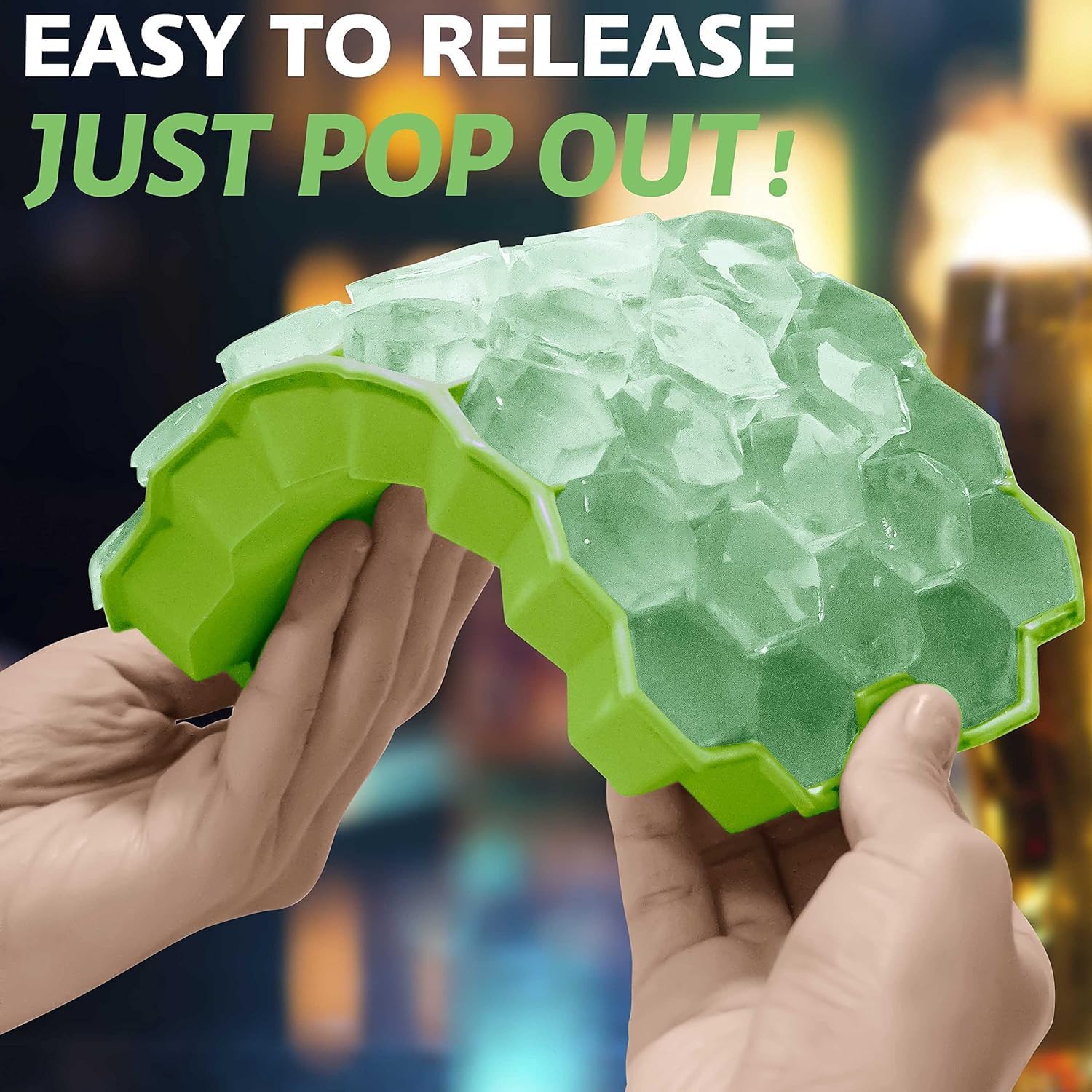 Honeycomb Silicone Ice Cube Tray with clear ice cubes being pulled out, against a blurred background.
