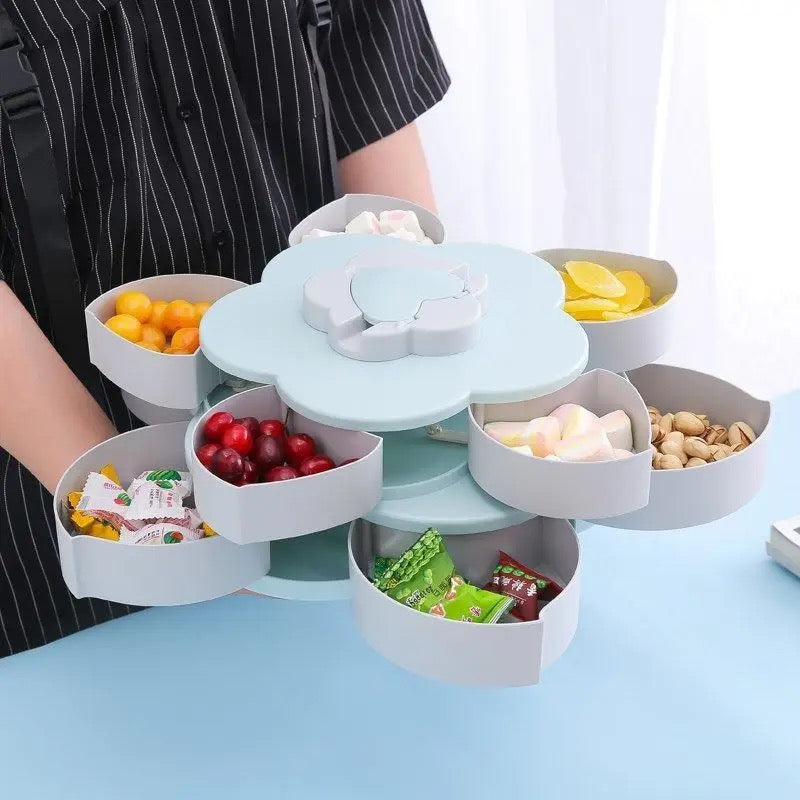 A person holding Flower Design Snack Box filled with nuts and candy 