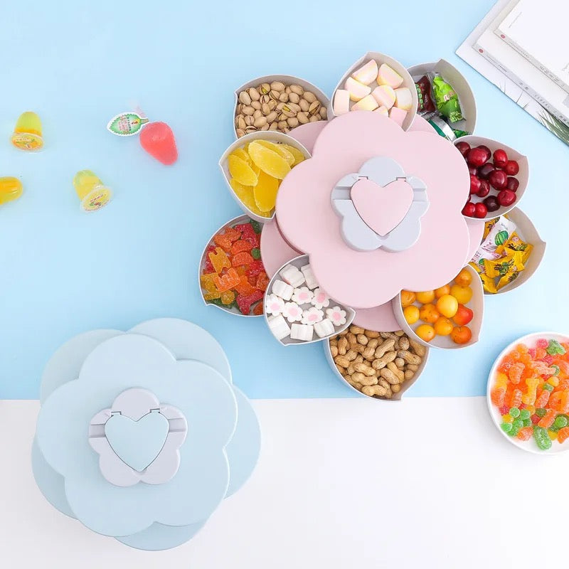2 Flower Design Snack Box placed on a blue-white surface in blue and pink color, one opened and filled with nuts and candy while the other one is closed 