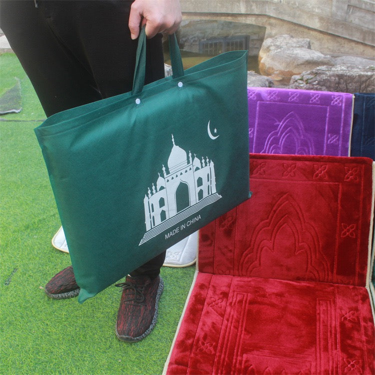 A person holding a cover with folded Islamic Foldable Prayer Mat in it next to other 2 Islamic Foldable Prayer Mat with backrest opened 