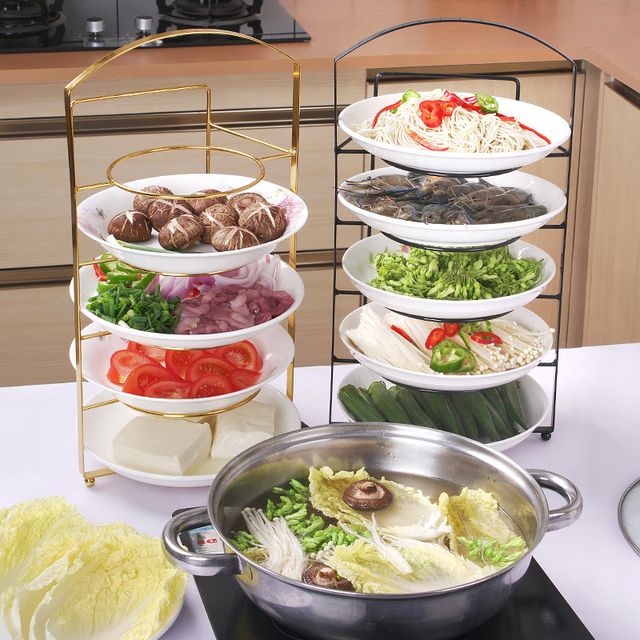 The Multi-Layer Wall Mount Kitchen Side Dish Storage Rack is placed in the kitchen next to some things