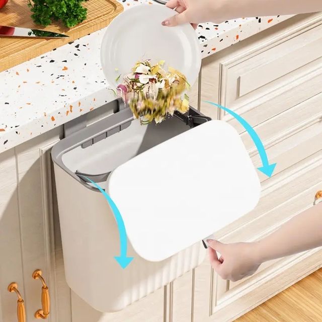 Someone is opening the 9L Trash Can Wall Mounted Hanging Bin for the Kitchen Cabinet Door