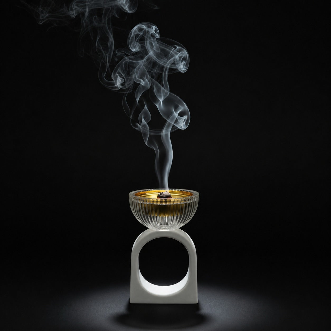Incense burner with smoke on a black background