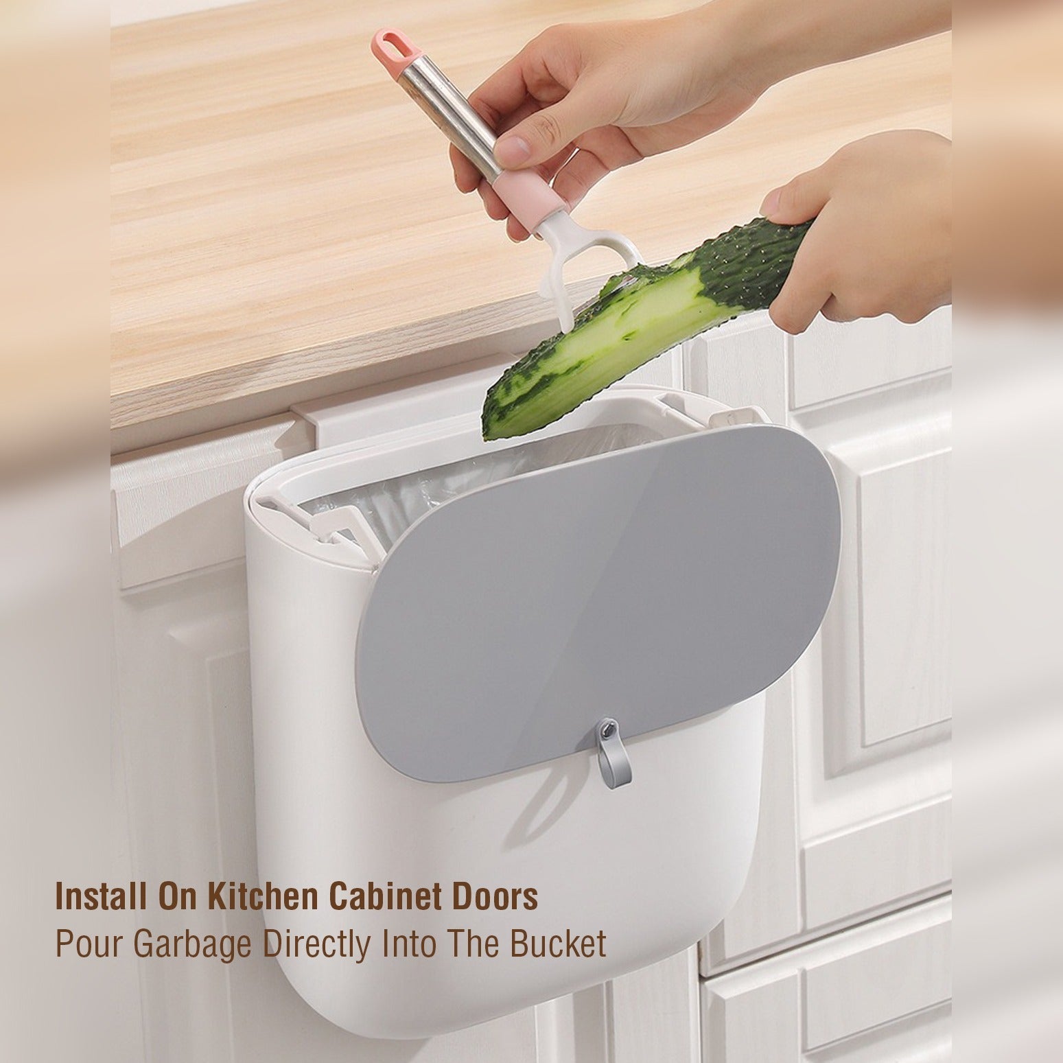 A Person is Peeling Cucmber in to Kitchen Garbage Bin.