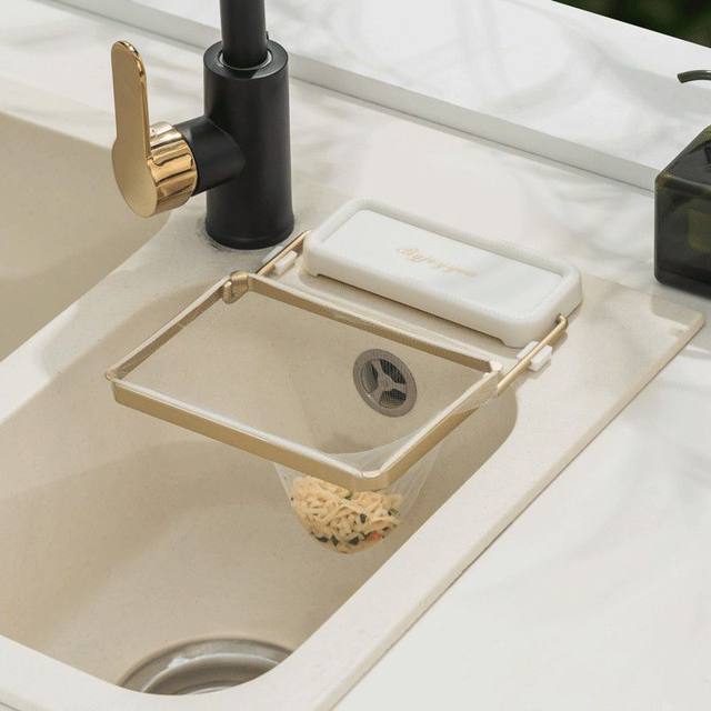 AKitchen Sink Corner Filter Drainer Strainer Rack is Attached On the Sink.