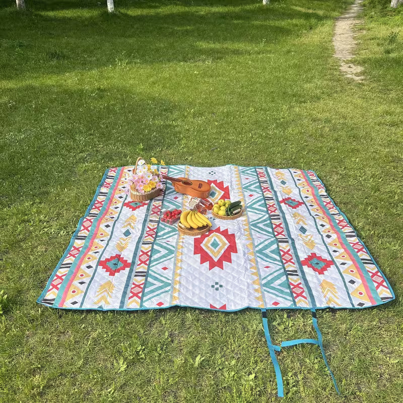 Large Waterproof Foldable Picnic Mat on grass with a basket of food