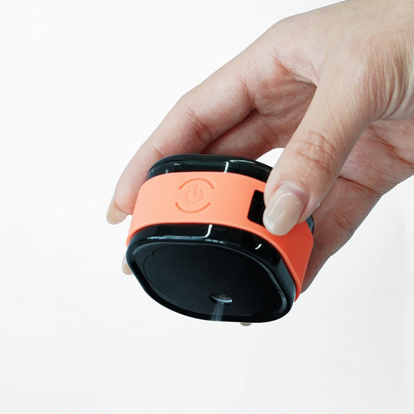 Hand holding a Macnoa MacX mistFlow Electric Coffee Atomizer against a white background