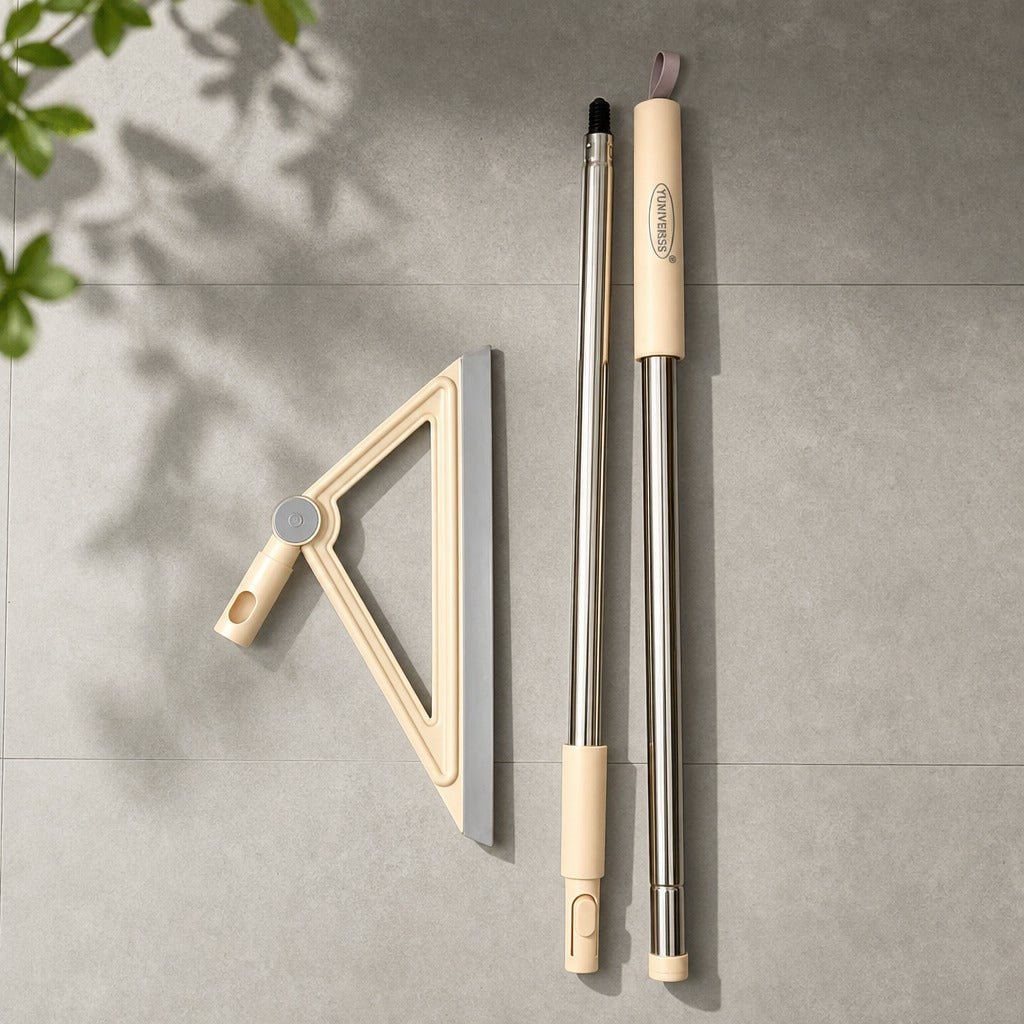 Cleaning tools including a squeegee and two brooms on a gray tiled floor.