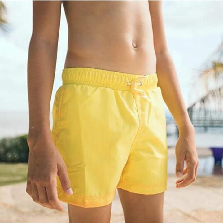 A Person is Wearing Men Color Changing  Beach Shorts.