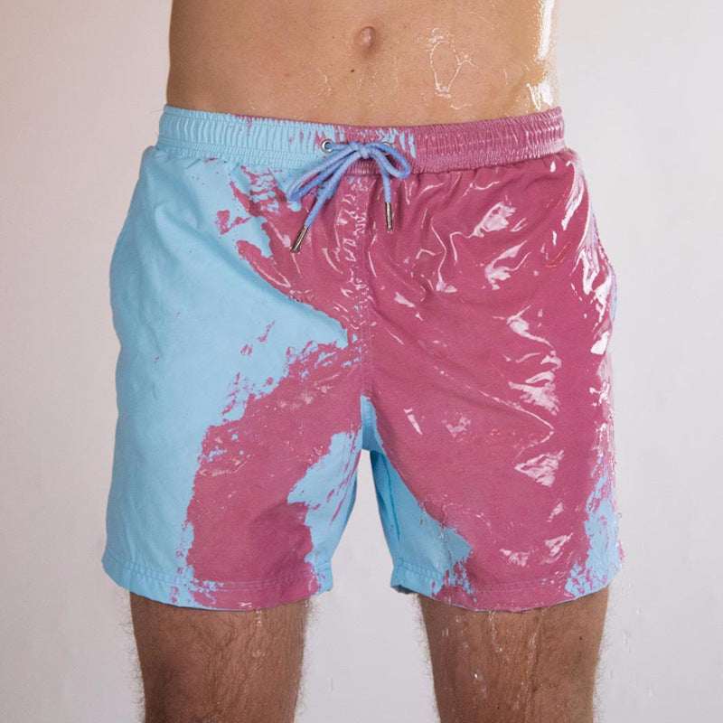 A Person is Wearing Men Color Changing  Beach Shorts in Blue Color.