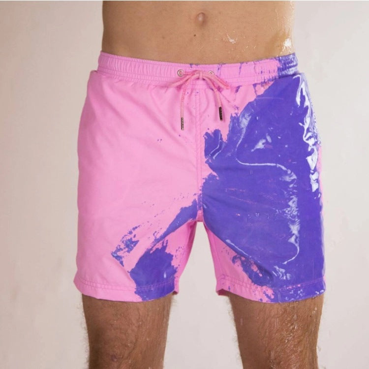 A Person is Wearing Men Color Changing  Beach Shorts in Pink Color.